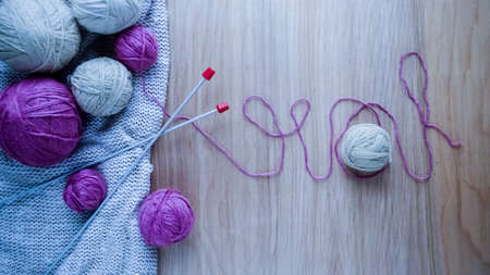 Balls of woolen yarn for knitting on the table. の写真素材