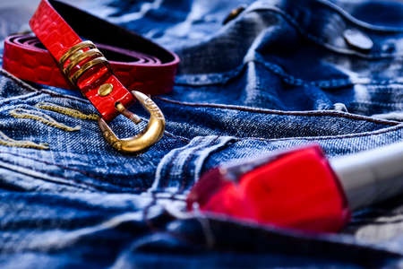 Denim clothes lying on the table with the glasses. Blue jeansの写真素材