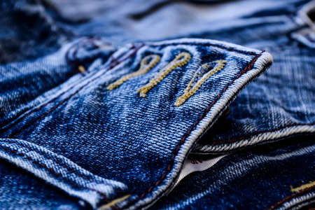 Denim clothes lying on the table with the glasses. Blue jeansの写真素材