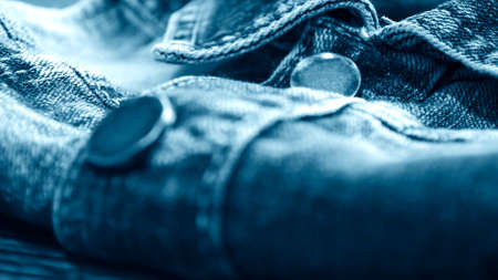 Denim clothes lying on the table with the glasses. Blue jeansの写真素材