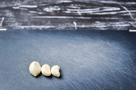 A composition of cloves of garlic on the table. の写真素材