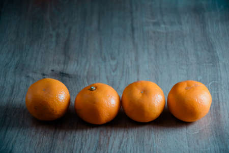 A composition of fresh mandarins on the table in the afternoonの写真素材