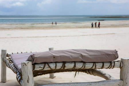 Beach with sun loungers and a place for rest at sunset. の写真素材