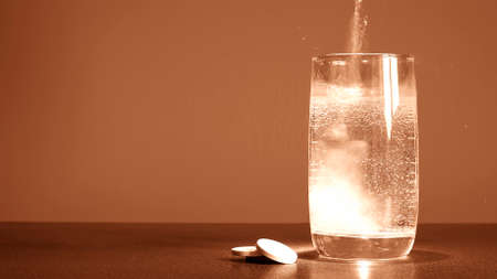The water in the glass and the medicine on the table. Transparenの写真素材