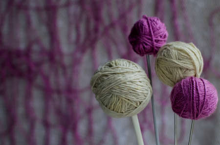 Balls of woolen yarn for knitting on the table. 