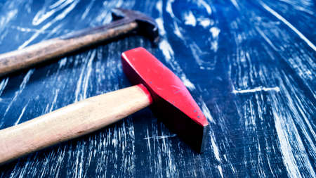 Hammer to repair lying on a wooden table. Mens housework. Work