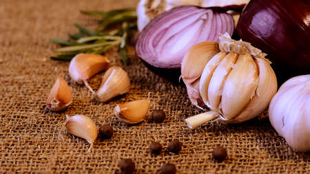 Garlic and cloves lying on a napkin. Healthy food and spices. Ad