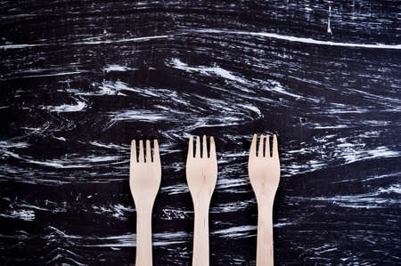 Silver fork lying on a wooden table. Cutlery for eating. Deviceの写真素材