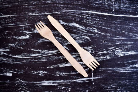 Silver fork lying on a wooden table. Cutlery for eating. Device