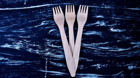 Silver fork lying on a wooden table. Cutlery for eating. Deviceの写真素材