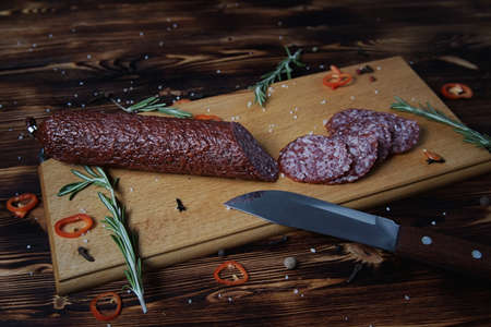 Smoked sausage on a wooden cutting boardの写真素材
