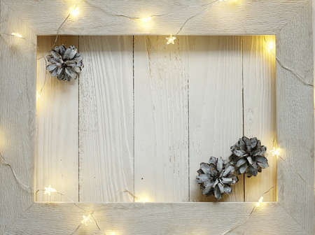 Christmas bright garlands on a wooden light backgroundの写真素材