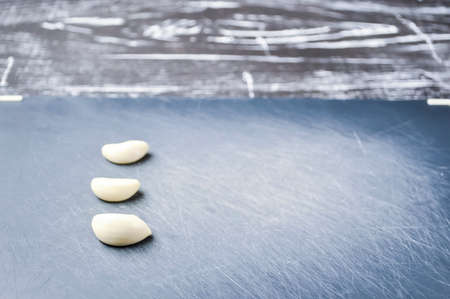A composition of cloves of garlic on the table. の写真素材