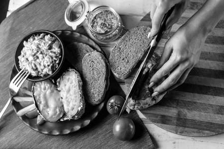 Preparation of potatoes with mushrooms and vegetables with sauce black and white posterの写真素材