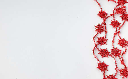 Christmas tree toys on a white background. Christmas decorations on a white surface. Balls and garland of red and silver colors on the table.
の写真素材