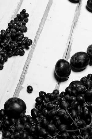 Prunes and grapes on the table black and white posterの写真素材