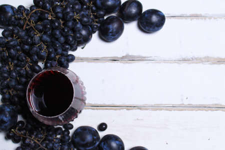 Wine and fruits on wooden tableの写真素材