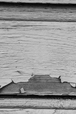 old paint on a dry wooden wall black and white posterの写真素材