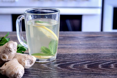 Drink from the lemon on the table. Lemon and ginger drink. The wの写真素材