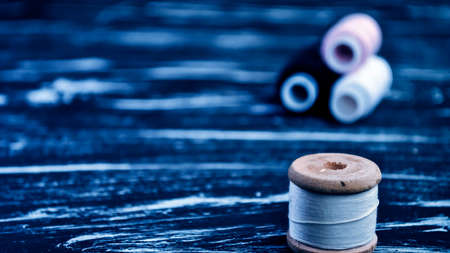 The spool of thread on the table. Thread on a reel for craft.の写真素材