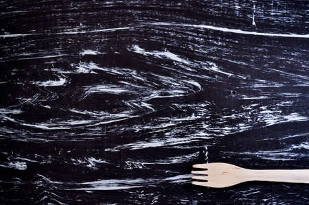 Silver fork lying on a wooden table. Cutlery for eating. Deviceの写真素材