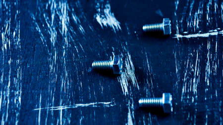 Nuts for repairs lying on a wooden table. Iron nuts and screws fの写真素材