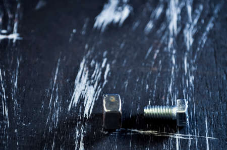 Nuts for repairs lying on a wooden table.の写真素材