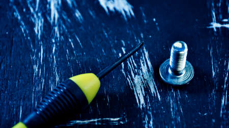 Nuts for repairs lying on a wooden table. Iron nuts and screws fの写真素材