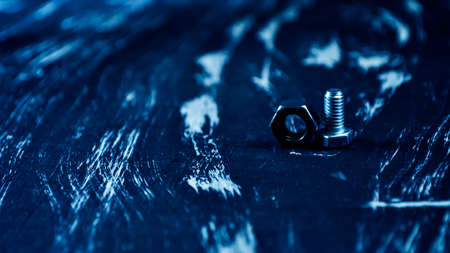 Nuts for repairs lying on a wooden table. Iron nuts and screws fの写真素材