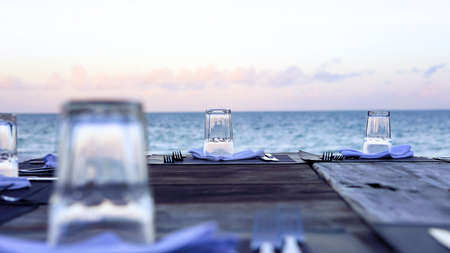 Wooden table and chairs on the beach. Furniture for lounging onの写真素材