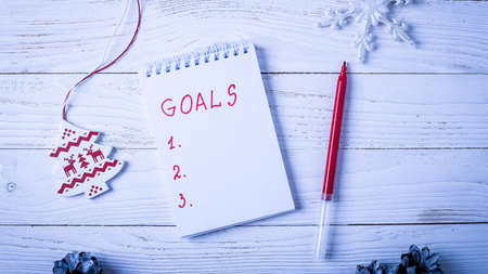 Workplace with a diary, decorations and gifts. New Years list o