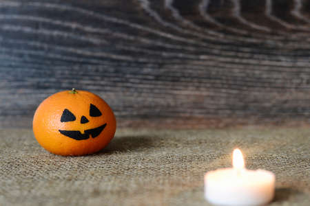 Painted scary faces on a holiday of halloween on orangeの写真素材