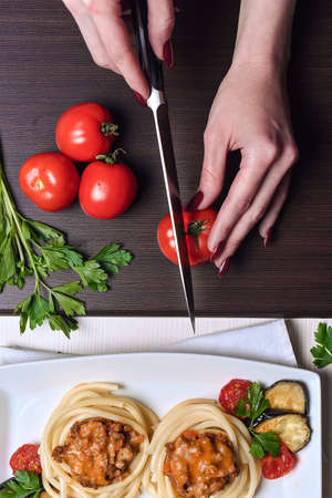 Italian pasta with meat on a plate in a cafe