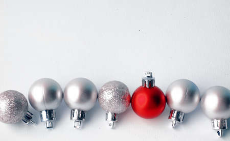 Christmas tree toys on a white background. Christmas decorations on a white surface. Balls and garland of red and silver colors on the table.
の写真素材