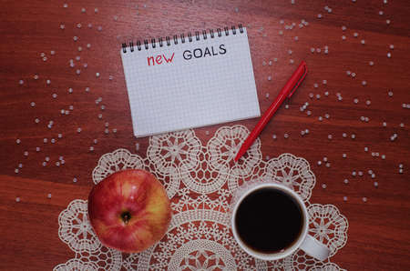 Notepad for entries on the table. Handle and paper on a wooden sの写真素材