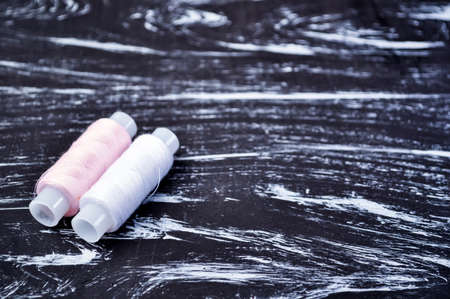 The spool of thread on the table. Thread on a reel for craft.の写真素材