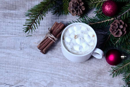 Coffee with marshmallows at the Christmas tree. Festive warming