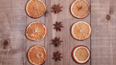 Dry slices of oranges lying on the table. Decorative ornament. Cの写真素材