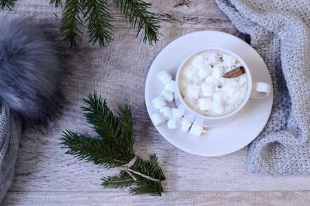 Coffee with marshmallows at the Christmas tree. Festive warming
