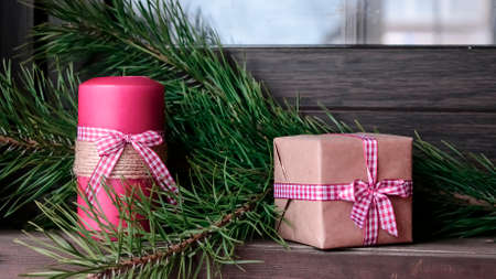 Candle on the table near the Christmas tree. Christmas present.の写真素材