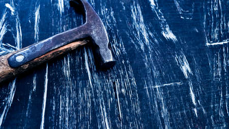 Hammer to repair lying on a wooden table. Mens housework. Worki
