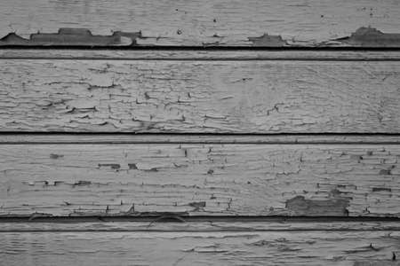 old paint on a dry wooden wallの写真素材