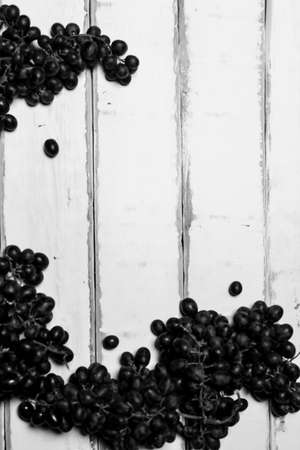 Grapes lying on a wooden tableの写真素材