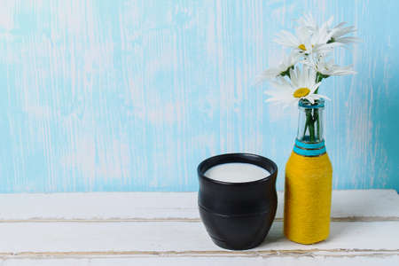 Flowers and milk on the tableの写真素材