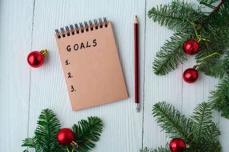 A Notepad on a wooden table near the Christmas tree. Notebook toの写真素材