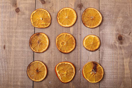 Dry slices of oranges lying on the table. Decorative ornament. Cの写真素材