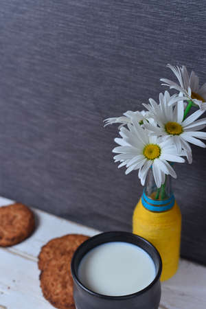 Chamomile and milk with cookiesの写真素材