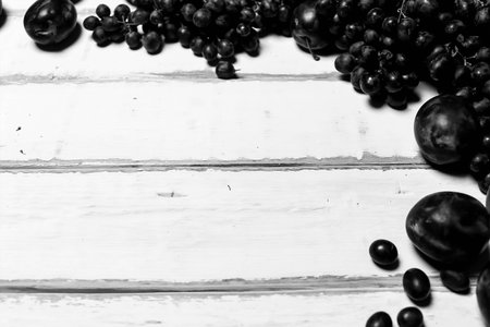 Prunes and grapes on the tableの写真素材