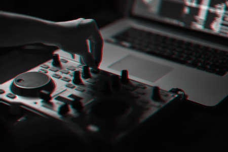 DJ mixer disco illuminated by searchlightsの写真素材