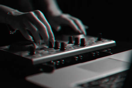 DJ mixer disco illuminated by searchlightsの写真素材